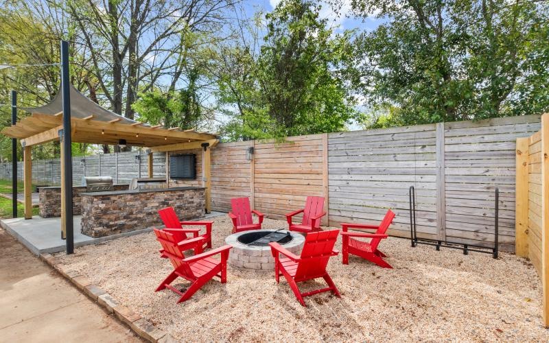 a group of red chairs in a backyard