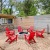 a group of red chairs in a backyard