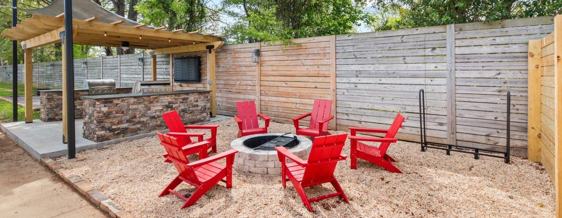 a group of red chairs in a backyard